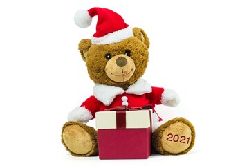 A teddy bear doll wearing santa set with red gift box isolated on white background,Christmas day and New Year's gifts
