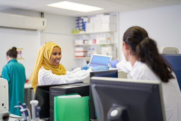 Female scientists using laptop in laboratory