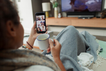 Woman video chatting with family on smart phone screen