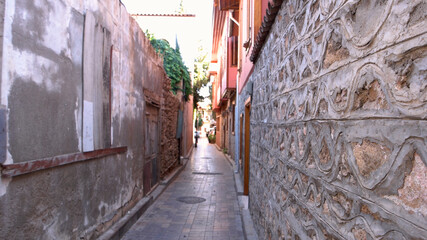 Fototapeta na wymiar Narrow street of old town Kaleici at Turkey. Buildings along a narrow street at Turkish city.