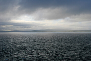 clouds over the sea with view of the Shetland isles