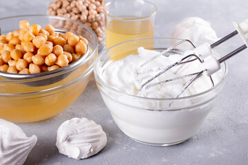 Vegan meringue, boiled chickpea and aquafaba. Vegan cooking concept. Substitute egg for vegan...