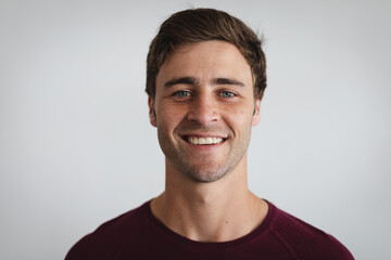 Fototapeta premium Portrait of caucasian man smiling against grey background