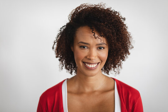 Portrait of african american woman smiling against grey background