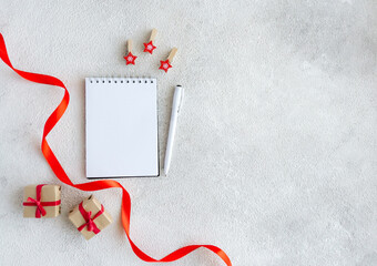 White blank notepad and Christmas red decor on gray background with copy space - 396823464