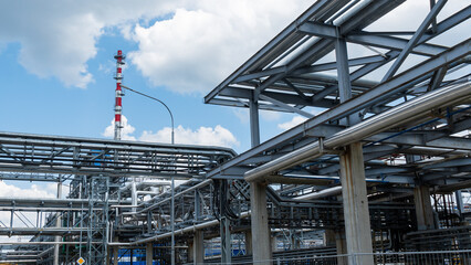 Refinery process area of petrochemical plant on classic blue sky with clouds background. Oil refining concept.