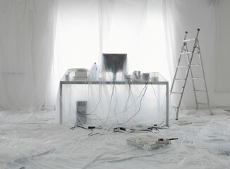 Desk And Computer Covered In Transparent Dust Sheets