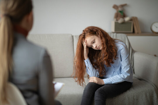 Child Psychologist. Worried Sad Teen Girl Having Session With Doctor