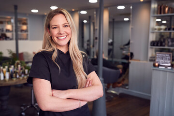 Portrait Of Female Stylist Or Business Owner In Hairdressing Salon
