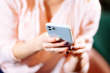 girl takes pictures on the phone. Blurred background and selected focus