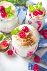 Cranberry layered Dessert breakfast in small jars for Christmas morning. Homemade baked Cranberry meringue dessert, with fresh cranberries and mint, copy space