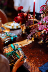 Sweet desserts in a plastic box on a decorated wedding table. Choosing a wedding cake. Cake fillings. Blurred background and selected focus.