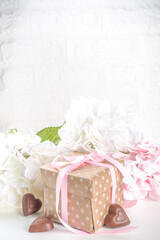 Fototapeta na wymiar Valentine gift with flowers and chocolates. Valentine day tender and sweet romantic background
