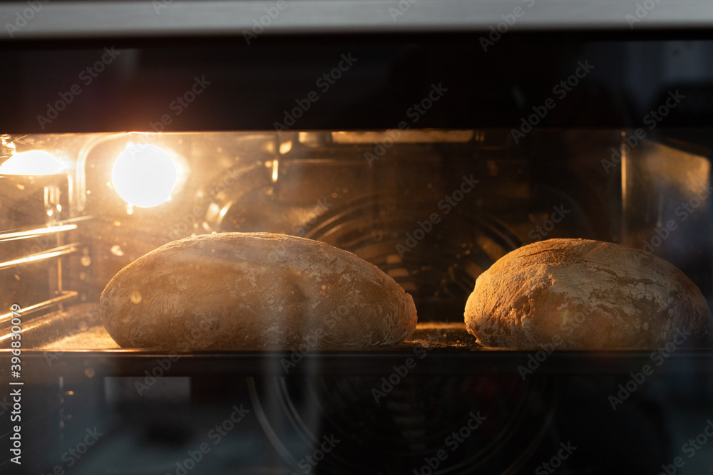 Wall mural Sourdough bread in the oven