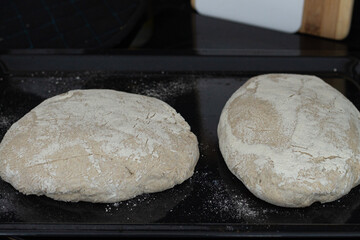 Unbaked sourdough bread on a cooking sheet