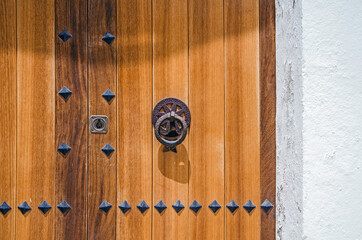 Classical wooden door in the white house in Ibiza, Spain