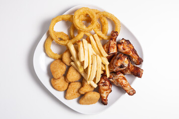 Combo plate with chicken wings, nuggets, squids and french fries