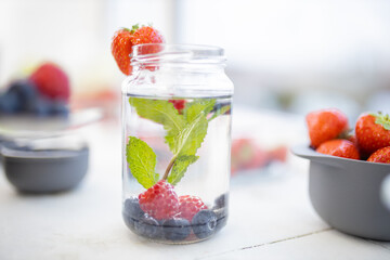 Strawberry on the edge of a mint and berries drink