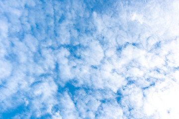 Beautiful blue clear sky with white clouds background in sunny day and copy space. Nature bright sky background image. Summer blue sky. Texture for Design. Natural cloudy Wallpaper.