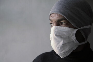 men with face masks fighting the coronavirus on grey background stock photo