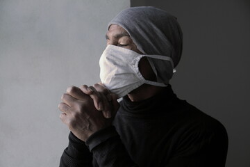 men with face masks fighting the coronavirus on grey background stock photo