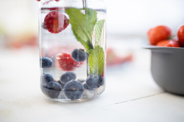 Raspberry, blueberry, and mint drink inside a jar