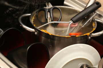 Dirty dishes inside a sink. House chores concept photo. 
