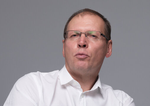 Mature adult man or businessman making duck lips for fun