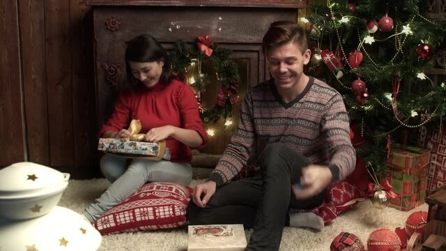 Family couple packing the presents at home. Relationship, family, christmas, new year, holiday concet.