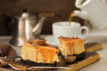 Cheesecake with salted caramel on brown  background. Copy space for text.