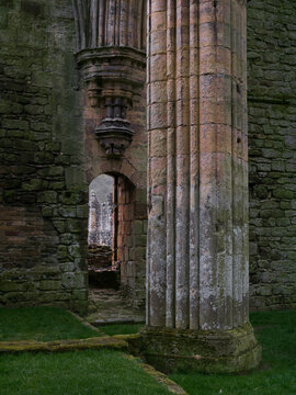 ruins of a medieval abbey with pillars and doorway during the reign of Henry VIII