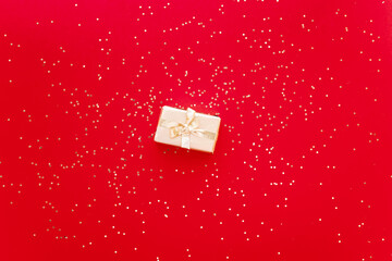 red Christmas or new year's background, plain composition of golden Christmas gifts with golden stars. Flatlay, empty space for greeting text.christmas concept.