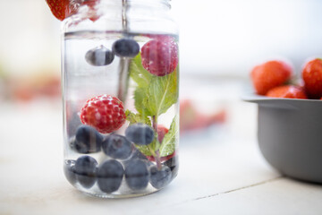Raspberry, blueberry, and mint drink inside a jar