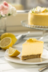 Obraz na płótnie Canvas Dessert - Lemon mouse Cheesecake. A slice of citrus cake with lemon and orange. half a lemon cake. cutaway lemon cake. sponge cake