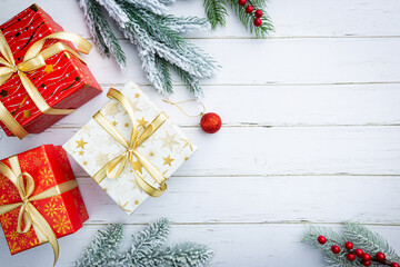 Christmas gift or present box on white wooden background, top view with copy space