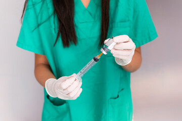 two hands, of a young nurse, holding a vaccine sample