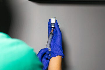 two hands holding a vaccine sample