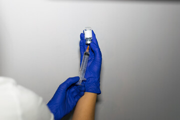 two hands holding a vaccine sample
