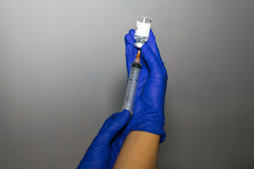 two hands holding a vaccine sample