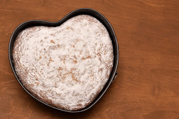 heart shaped cake dusted with powdered sugar, freshly baked with love for birthday and holiday