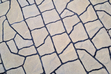 Decorative sidewalk in perspective in the form of natural stone