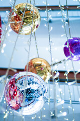 Christmas decoration of the room, silver Christmas balls that reflect garlands