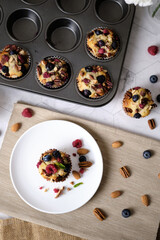 mixed berry low carb Keto Diet muffin with almond and nut. set on cafe table.