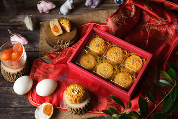 Box of Mooncake a Chinese traditional pastry for Mid-Autumn festival. set on rustic wooden table.