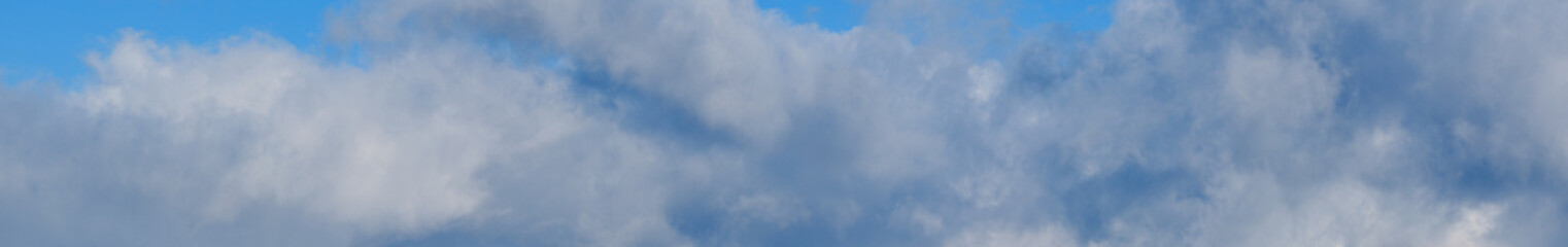 Blue sky with clouds, wide cloudscape background panorama