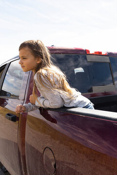 Serene Girl Riding In Back Of Pickup Truck