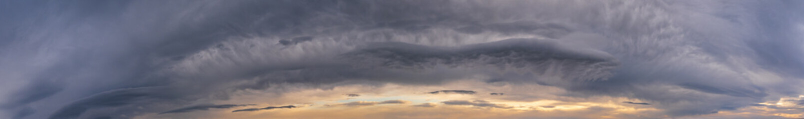 Fluffy clouds in evening overcast sky panoramic view. Climate, environment and weather concept sky background.