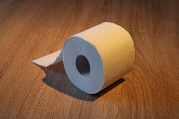 Rolls of toilet paper on a wooden underground. A hamster purchases concept during COVID-19