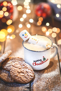 Funny marshmallow snowman in red cup of hot chocolate
