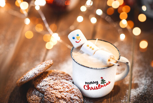 Funny marshmallow snowman in red cup of hot chocolate
